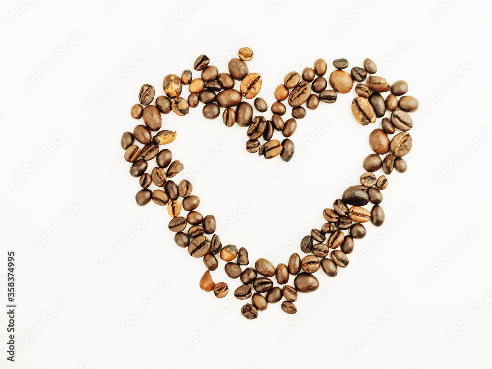 Coffee beans isolated on a white background. Heart made from coffee beans with place for text. Freshly roasted coffee. Love. Coffee beans isolated on a white background. Heart made from coffee beans with place for text. Freshly roasted coffee. Love.