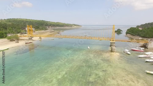 Yellow bridge over the river at Nusa Ceningan, Bali - Indonesia. Aerial Shot