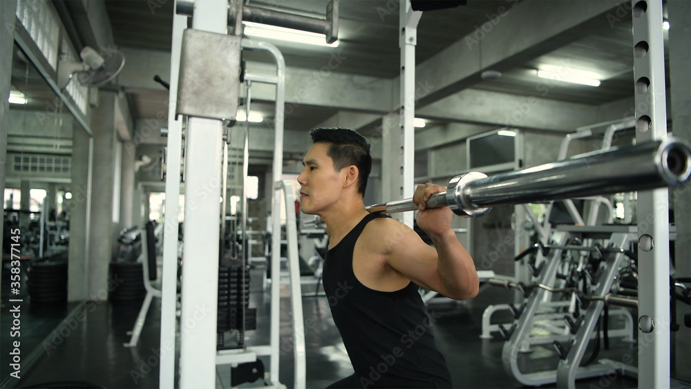 Exercise concepts. Young men exercise by squats in the gym. 4k Resolution. Exercise concepts. Young men exercise by squats in the gym. 4k Resolution.