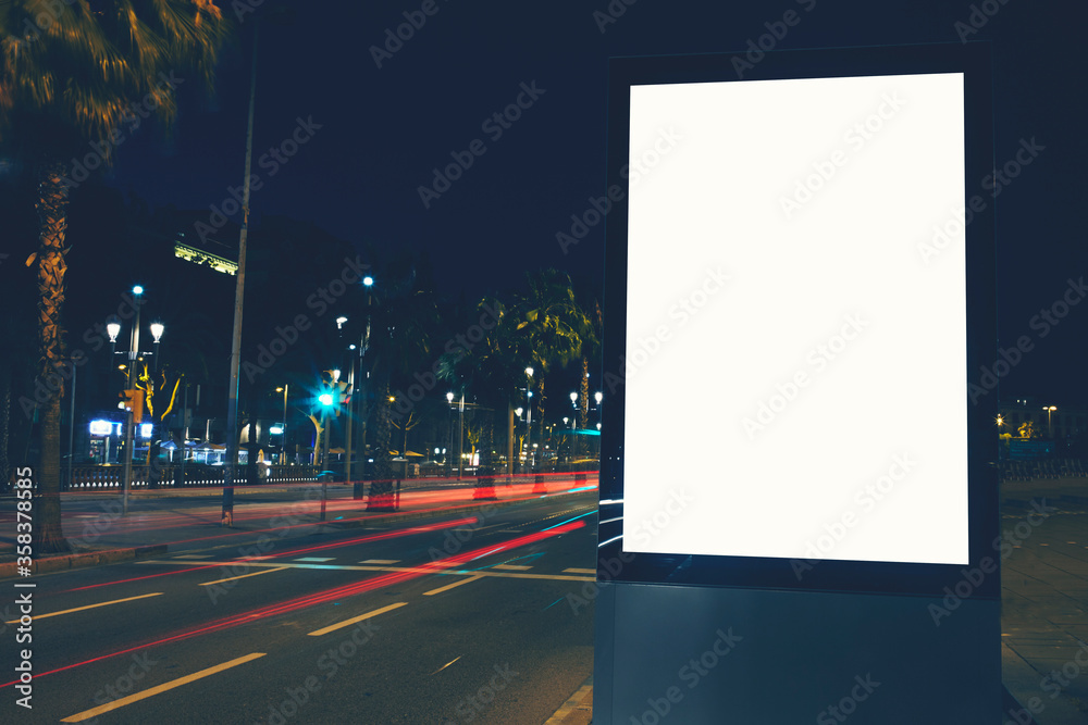 Illuminated blank billboard with copy space for your text message or content, public information board in night city with beautiful dusk on background, advertising mock up banner in metropolitan city Illuminated blank billboard with copy space for your text message or content, public information board in night city with beautiful dusk on background, advertising mock up banner in metropolitan city