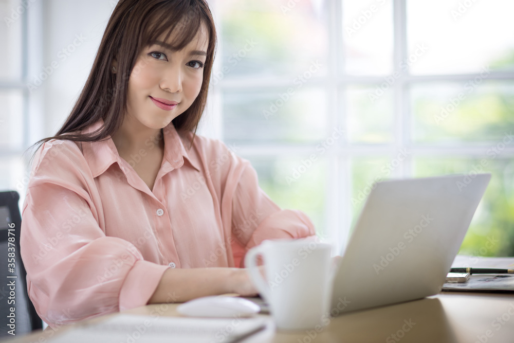 Beautiful Asian businessman wearing a pink shirt is smiling confidently and looking at the camera. Asian business women concept Beautiful Asian businessman wearing a pink shirt is smiling confidently and looking at the camera. Asian business women concept