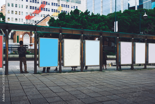 Fototapeta Naklejka Na Ścianę i Meble -  Bus station billboards with blank copy space posters for advertising text message or promotional content, empty mock up Lightbox for information, bus stop shelter clear display in urban city street