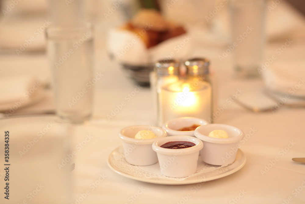 Candlelight restaurant table place setting, bread, jam, butter, warm, wedding, celebration, dining, ambiance, breakfast, cafe Candlelight restaurant table place setting, bread, jam, butter, warm, wedding, celebration, dining, ambiance, breakfast, cafe