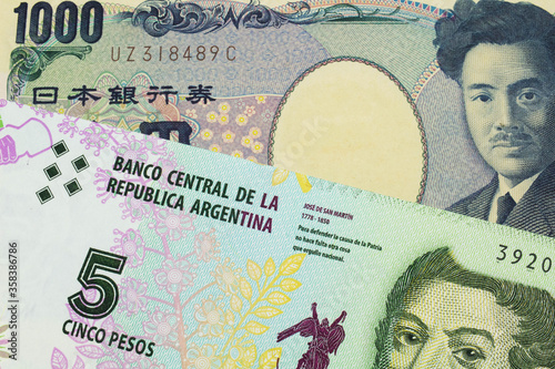 Wallpaper Mural A macro image of a Japanese thousand yen note paired up with a colorful five peso note from Argentina.  Shot close up in macro. Torontodigital.ca
