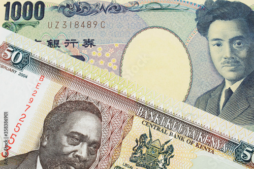 A macro image of a Japanese thousand yen note paired up with a colorful fifty shilling bank note from Kenya.  Shot close up in macro. photo