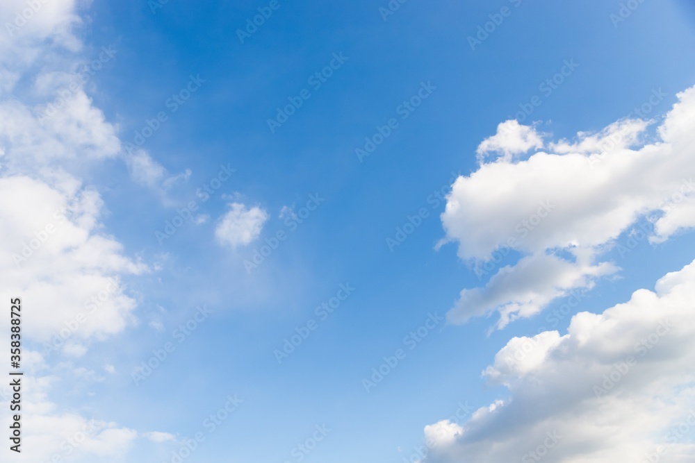 White clouds in the blue sky. Beautiful sky background, copy space