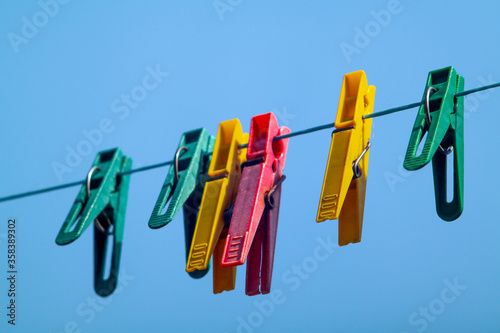colorful clothespins hanging on a clothesline