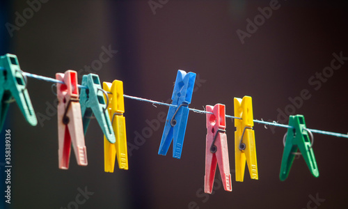 colorful clothespins hanging on a clothesline