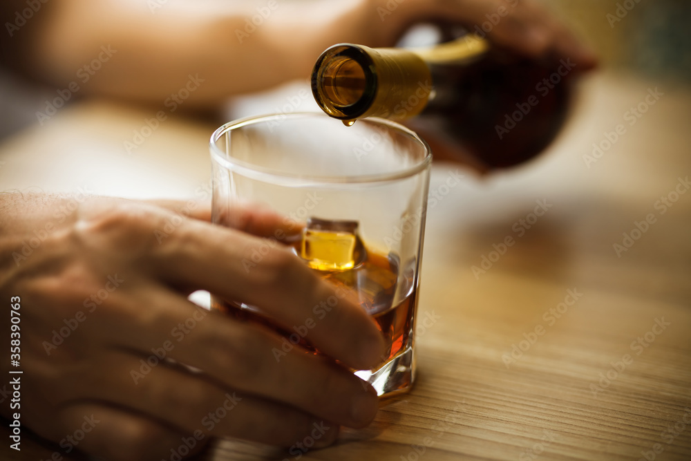 Hand with a glass of alcohol. The problem of alcoholism. Hand with a glass of alcohol. The problem of alcoholism.