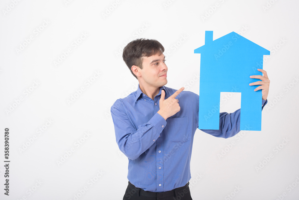 Portrait of handsome man is holding paper home on white background Portrait of handsome man is holding paper home on white background