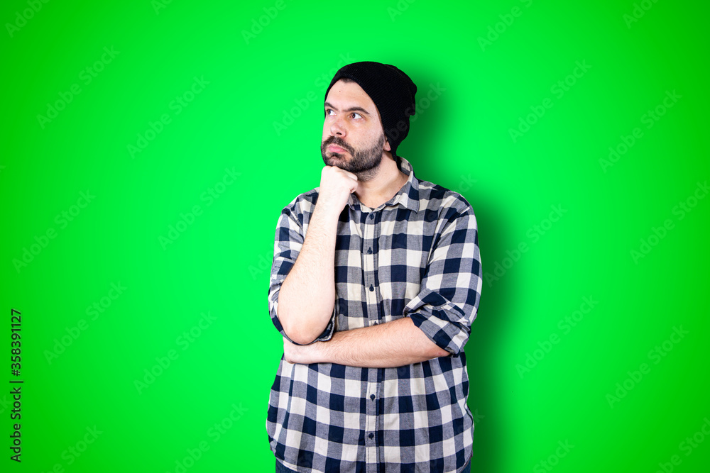 Caucasian handsome man isolated on chroma background thinking an idea while looking up Caucasian handsome man isolated on chroma background thinking an idea while looking up