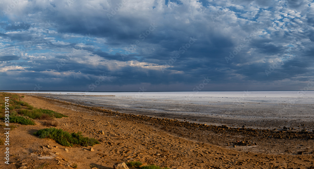 Elton Salt Lake at sunset with beautiful clouds and warm sunny color. Elton Salt Lake at sunset with beautiful clouds and warm sunny color.