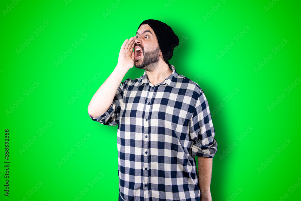 Screams, hatred, anger. Emotionally angry crying man screaming on the chroma studio background. Emotional and young face. Half length male portrait. Human emotions, facial expression concept Screams, hatred, anger. Emotionally angry crying man screaming on the chroma studio background. Emotional and young face. Half length male portrait. Human emotions, facial expression concept