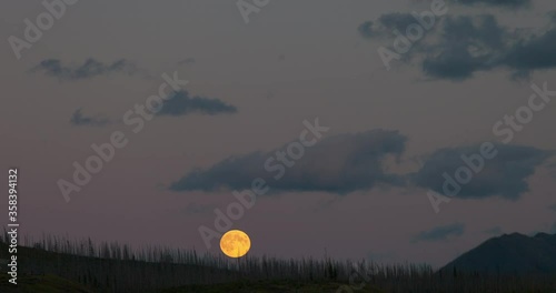 Lockdown time lapse shot of moonrise over landscape at national park against sky - Jasper National Park, Canada