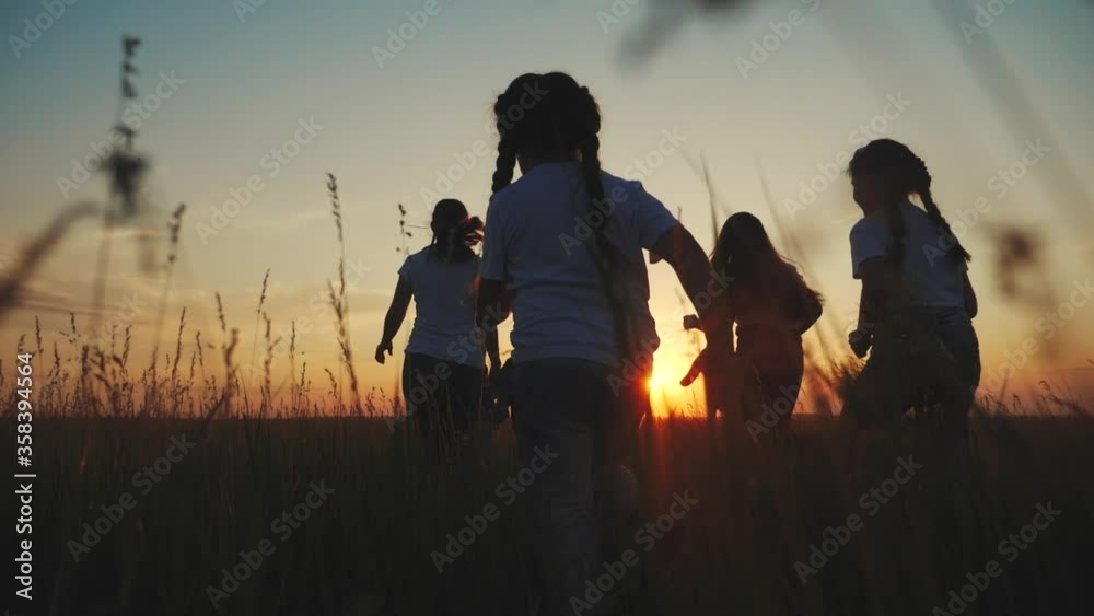 happy family children kids together run in the park at sunset silhouette. people in the park concept mom dad daughter and son joyful run. parents and little baby child fun summer vacation running happy family children kids together run in the park at sunset silhouette. people in the park concept mom dad daughter and son joyful run. parents and little baby child fun summer vacation running