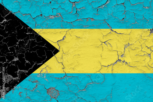 Bahamas flag close up grungy, damaged and weathered on wall peeling off paint to see inside surface. Vintage concept.
