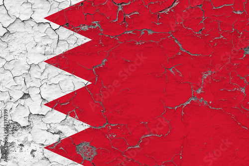 Bahrain flag close up grungy, damaged and weathered on wall peeling off paint to see inside surface. Vintage concept.