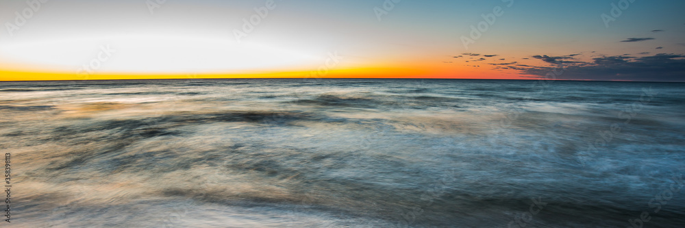 Waiting for sunrise on the beach in Chalupy. A quiet and peaceful place ideal for rest and relaxation. Famous naturist beach. Widescreen(panoramic) banner of vacations landscape. Waiting for sunrise on the beach in Chalupy. A quiet and peaceful place ideal for rest and relaxation. Famous naturist beach. Widescreen(panoramic) banner of vacations landscape.