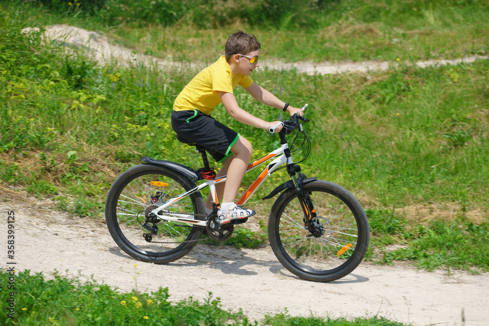 A child riding a bicycle in the park. Healthy lifestyle