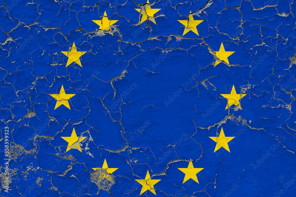 European Union flag close up grungy, damaged and weathered on wall peeling off paint to see inside surface. Vintage concept. European Union flag close up grungy, damaged and weathered on wall peeling off paint to see inside surface. Vintage concept.