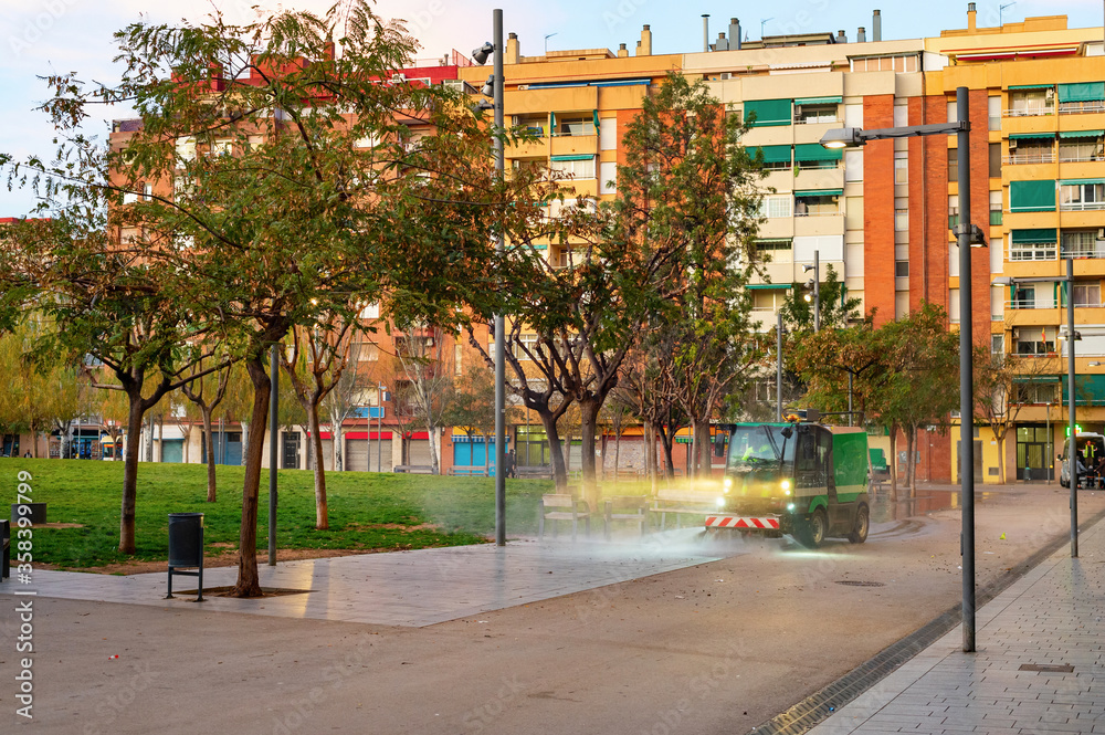 Watering machine, park, apartments, Barcelona