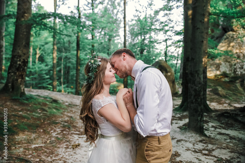 Bride and groom in forest on their wedding, photo session. © ALEXSTUDIO