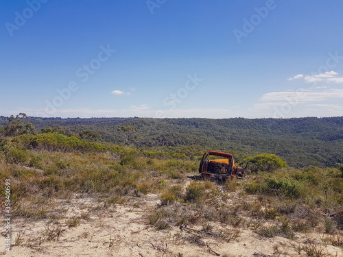 abandoned car on plains of blue mountains