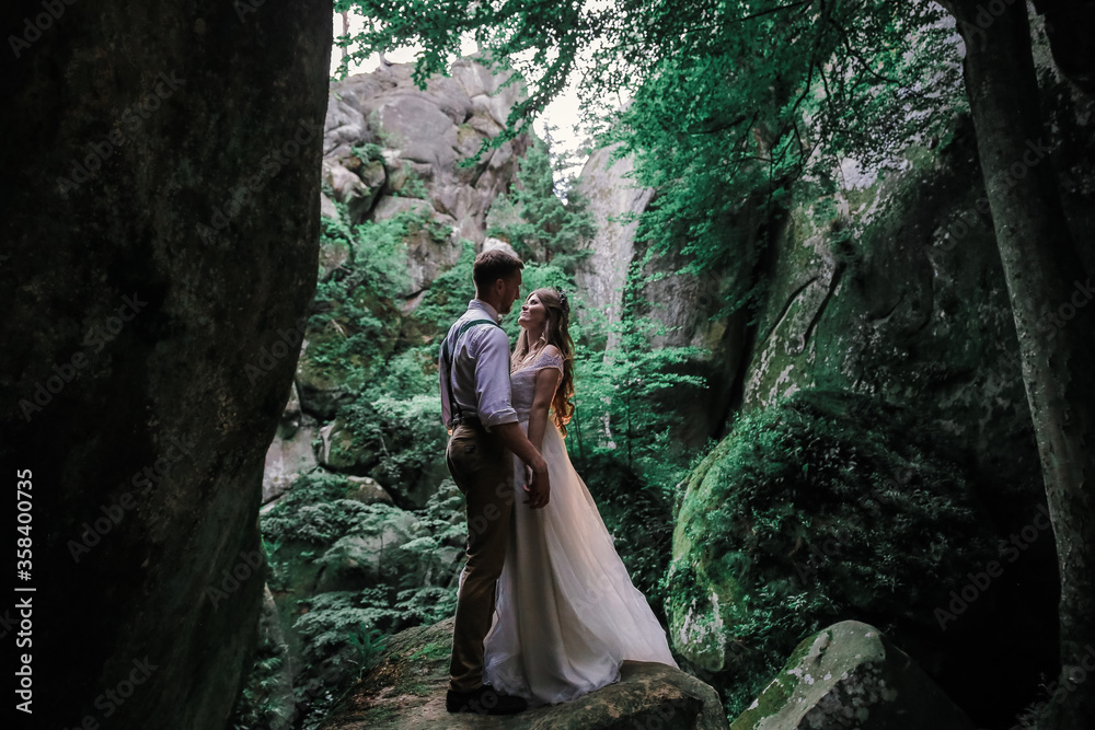Bride and groom in forest on their wedding, photo session.