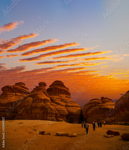 Tourists at Mada'in Saleh archaeological sites near Al Ula at Sunset, Saudi Arabia