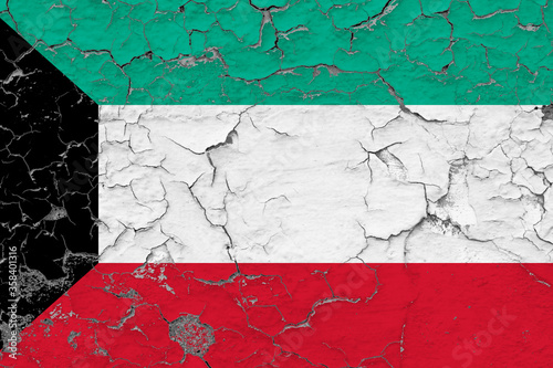 Kuwait flag close up grungy  damaged and weathered on wall peeling off paint to see inside surface. Vintage concept.