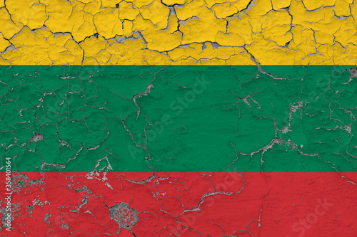 Lithuania flag close up grungy, damaged and weathered on wall peeling off paint to see inside surface. Vintage concept.