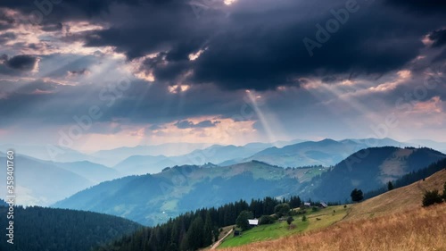 Time lapse of sun rays emerging though the dark storm clouds
