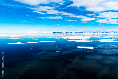 Cloudy sky and Ice pieces on the water in Arctic © Anton Ivanov Photo