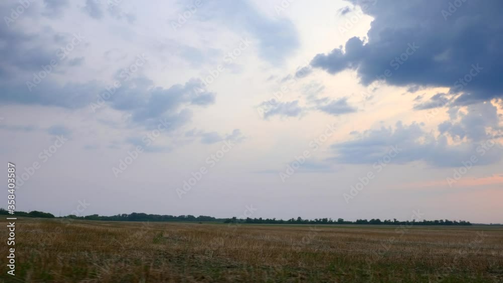 Driving Along Cultivated Farm Field. Sky Horizon over Rural Landscape Driving Along Cultivated Farm Field. Sky Horizon over Rural Landscape
