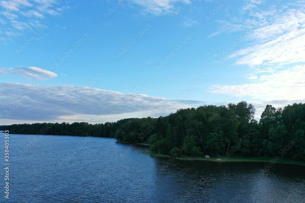 natural landscape with river forest and fantastic clouds in the sky