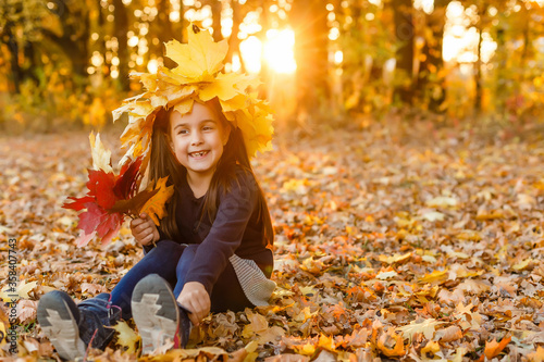 happy little child, girl laughing and playing in the autumn on the nature walk outdoors
