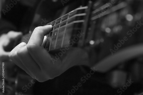 Closeup photo of electric guitar player hands.  Soft focus.