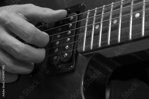 Closeup photo of electric guitar player hand. Soft focus.