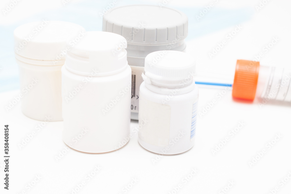 medical jars with pills on white table medical jars with pills on white table