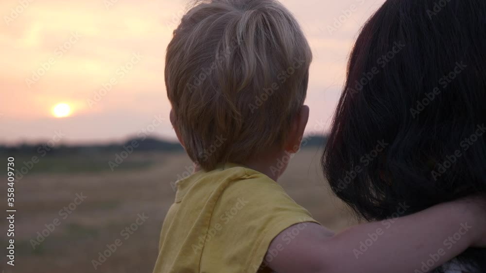 Mother And Son Look on Sunset above Horizon on Farm Field Mother And Son Look on Sunset above Horizon on Farm Field