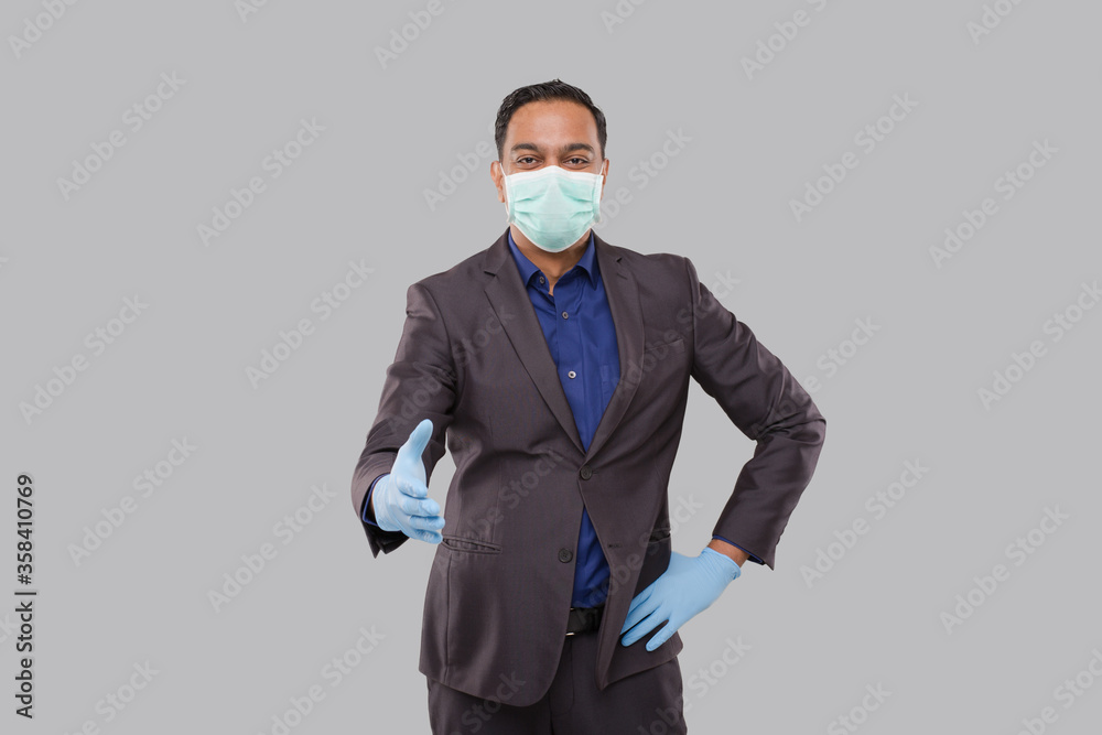 Indian Businessman offering hand to shake Wearing Medical Mask and Gloves. Greeting and welcoming gesture. Business advertisement concept. Businessman Hand Shake Indian Businessman offering hand to shake Wearing Medical Mask and Gloves. Greeting and welcoming gesture. Business advertisement concept. Businessman Hand Shake