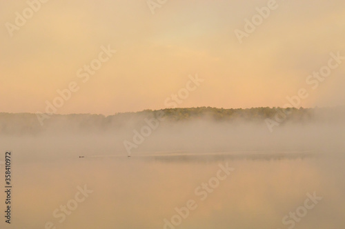 Morning fog obscuring lake and forest