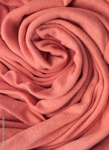 Pink fabric rolled up like a spiral resembling rose flower
