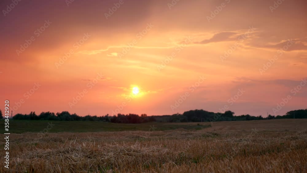 Scenic Sunset Over Mowed Wheat Field Scenic Sunset Over Mowed Wheat Field