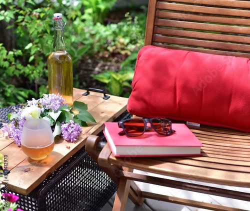 Outdoor patio seating in beautiful tranquil backyard sanctuary with beautiful landscaping for mindful relaxation on a warm summer afternoon during quarantine stay at home vacation