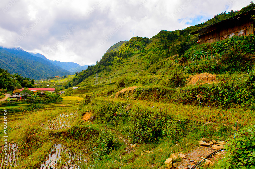 It's Mountains with green plants and rice terraces in Vietnam with cloudy sky, end of the rain season