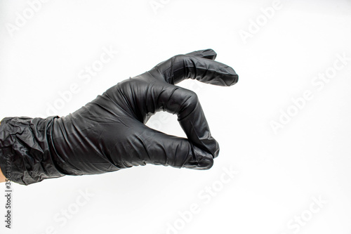 Hand in black gloves, protection. The concept of cleanliness