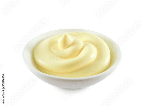 Mayonnaise or cream swirl in ceramic bowl isolated on white background side view