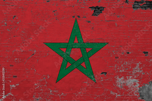 Morocco flag on grunge scratched concrete surface. National vintage background. Retro wall concept.
