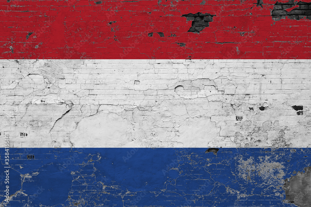 Netherlands flag on grunge scratched concrete surface. National vintage background. Retro wall concept.